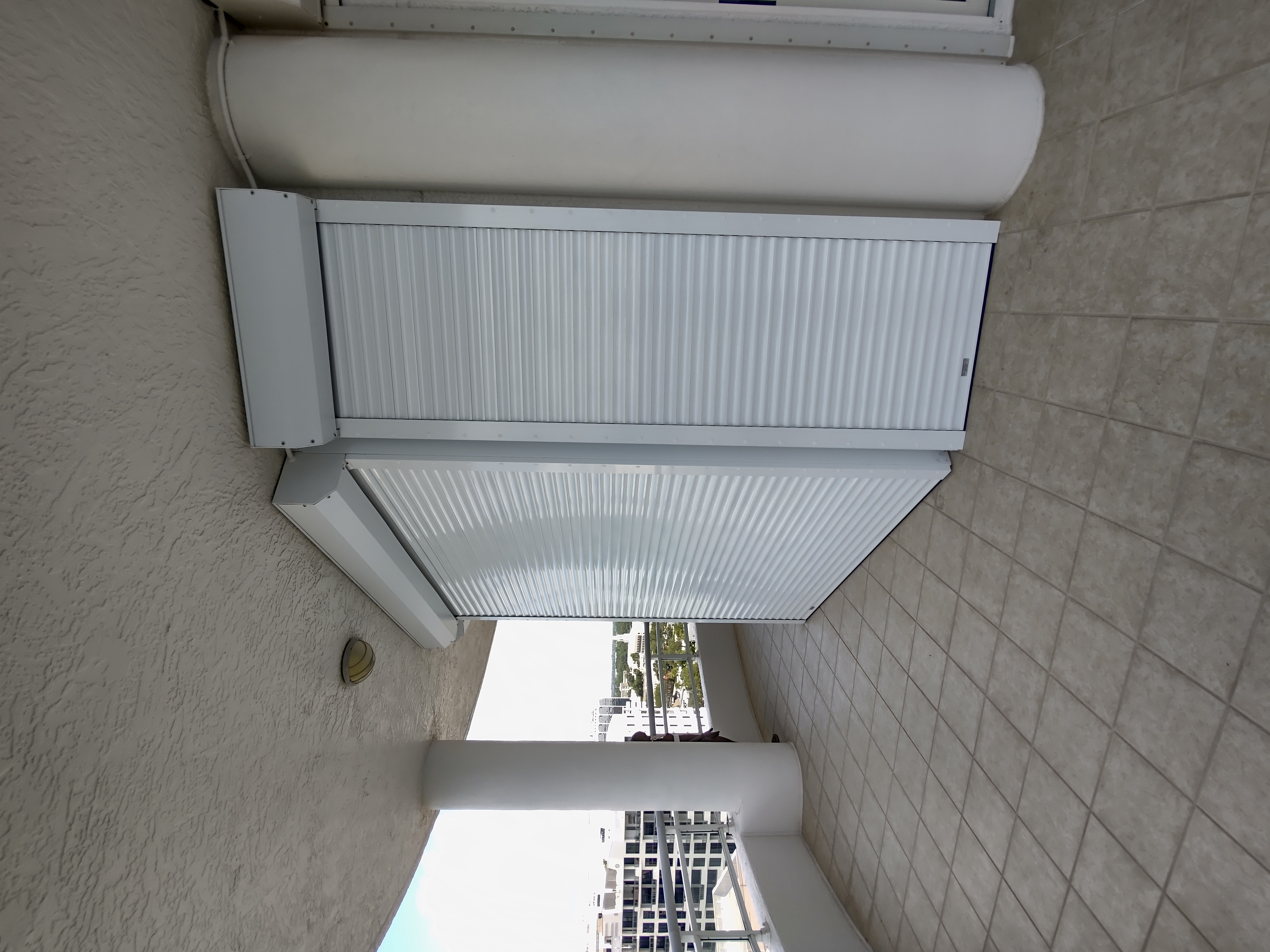 Roll-down screens retracted on a luxury waterfront condo with Sarasota Bay views