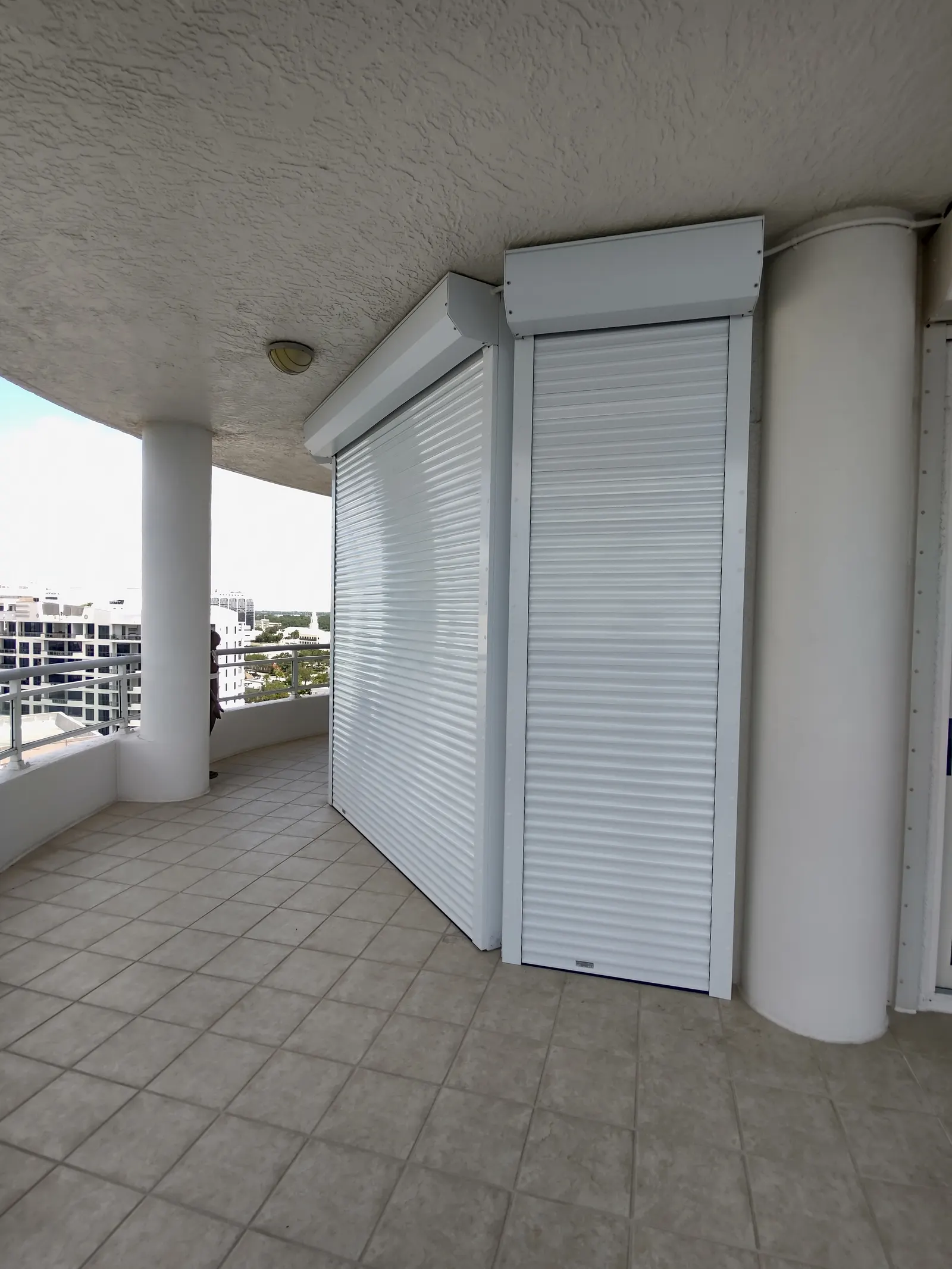 Roll-down screens retracted on a luxury waterfront condo with Sarasota Bay views